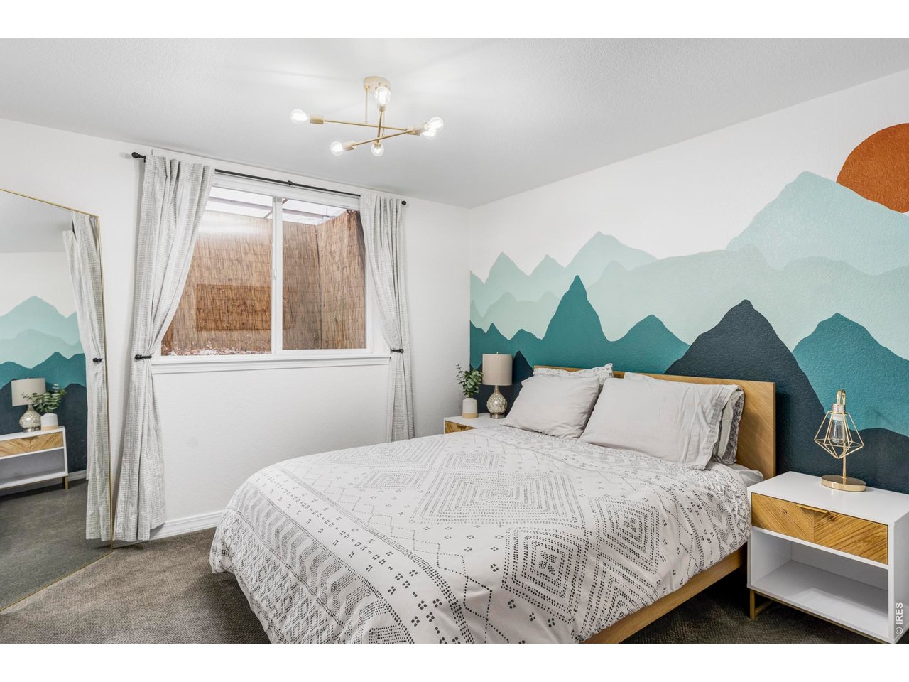 4954 10th Street Boulder, CO 80304 - Photo 18 of 21 a bedroom with a bed lamps and a large mirror