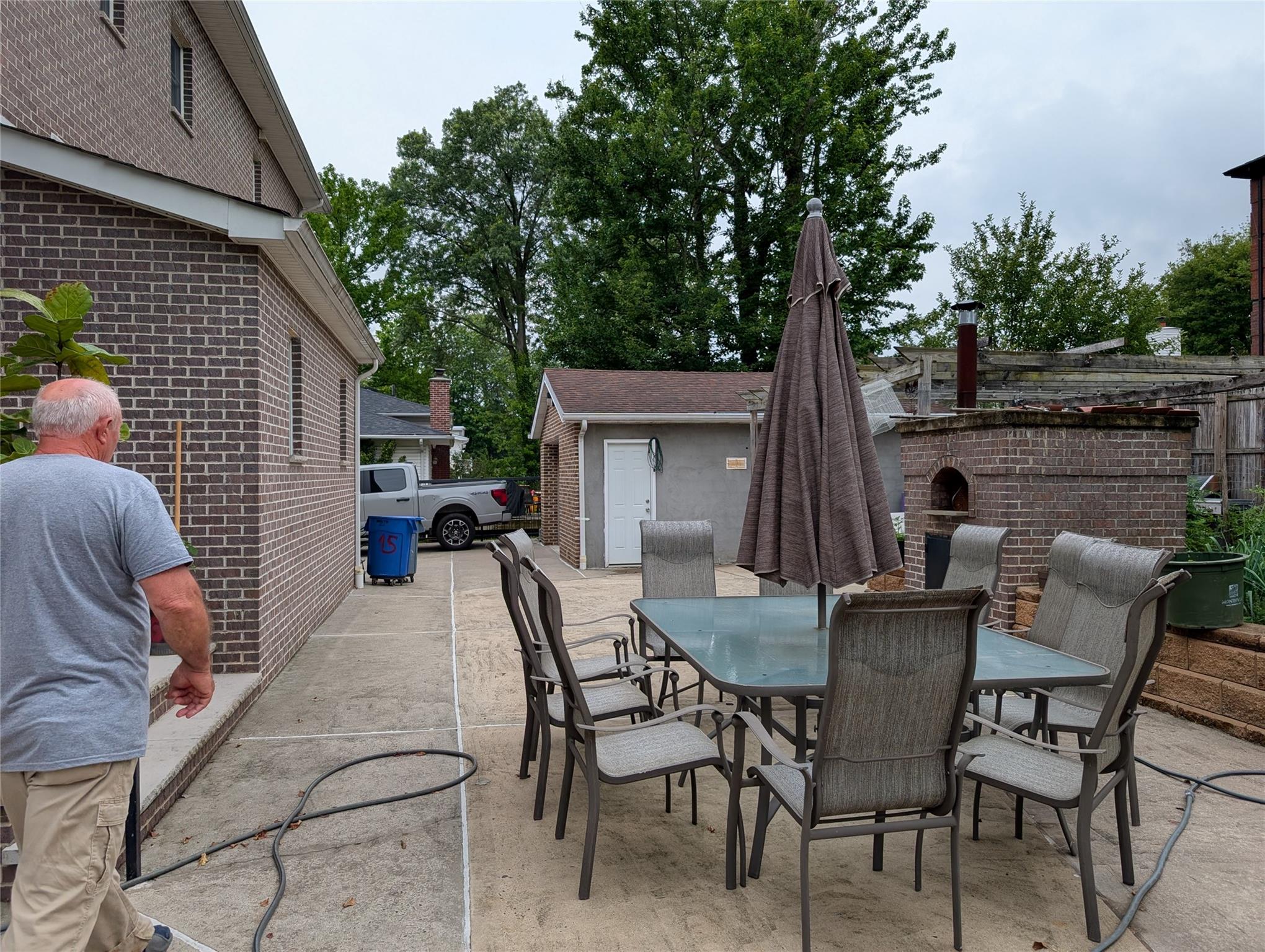 15 Lenzie Street Staten Island, NY 10312 - Photo 18 of 19 a view of a patio with table and chairs with wooden fence and floor