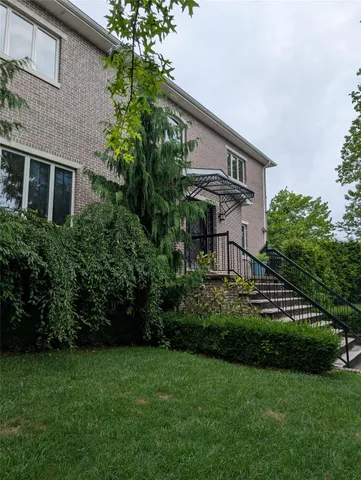 a front view of a house with a garden