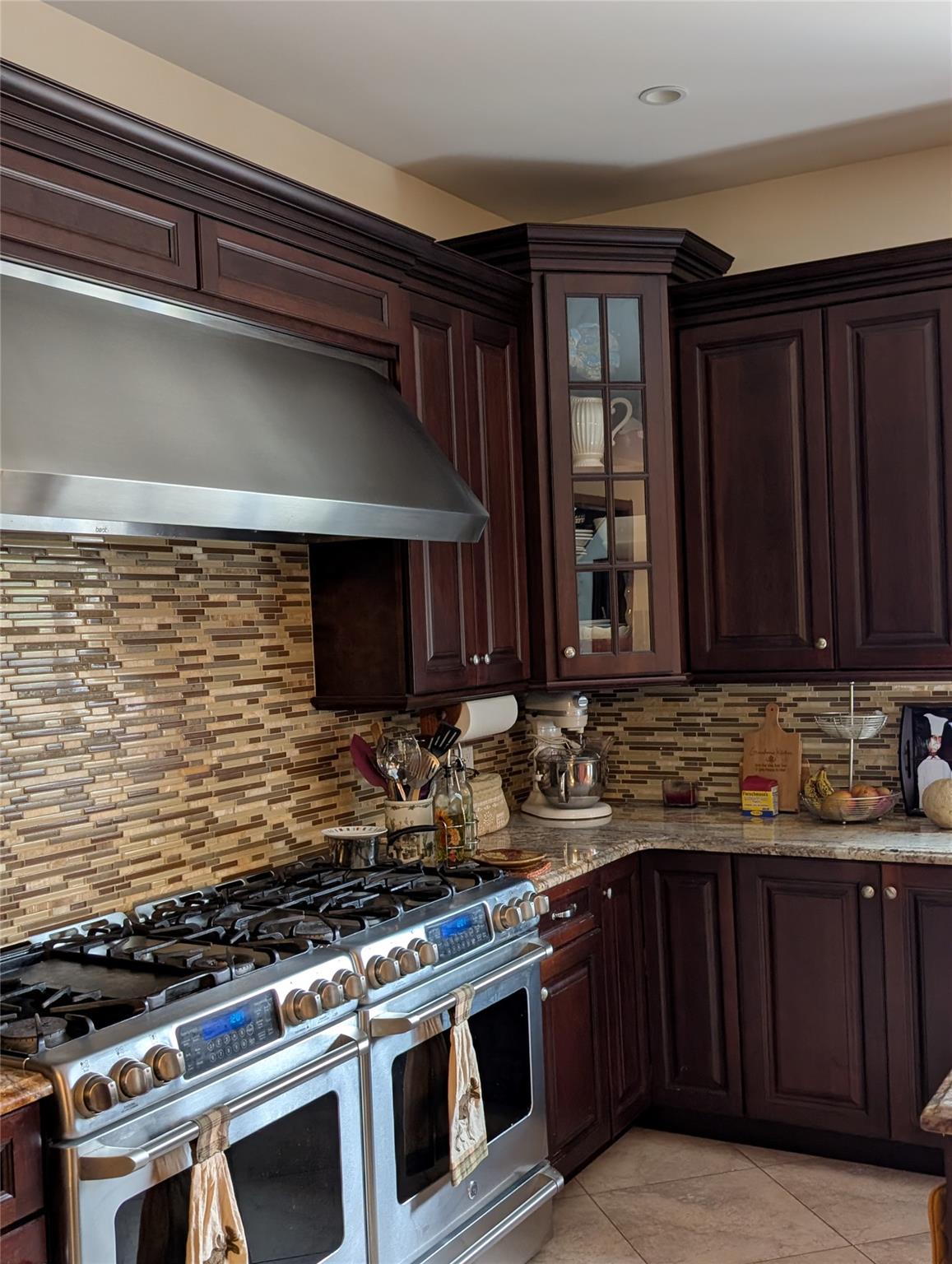 15 Lenzie Street Staten Island, NY 10312 - Photo 5 of 19 a kitchen with stainless steel appliances wooden cabinets and a stove top oven
