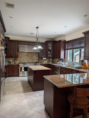 a kitchen with stainless steel appliances granite countertop a sink counter space cabinets and a counter space