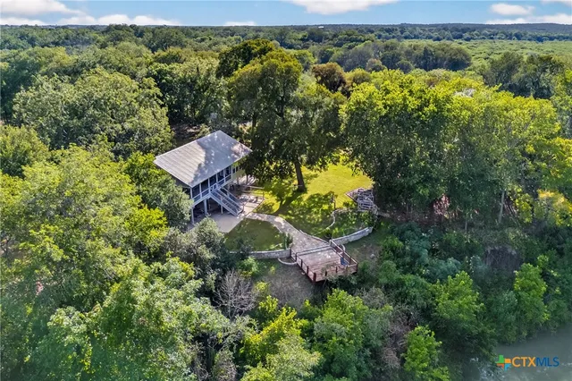 an aerial view of a house with a yard