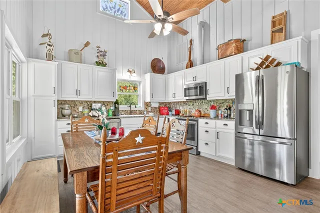 a dining room with furniture and wooden floor