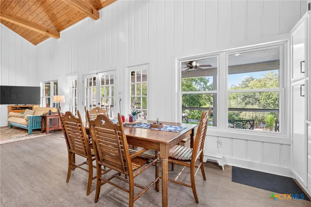 a dining room with furniture and wooden floor