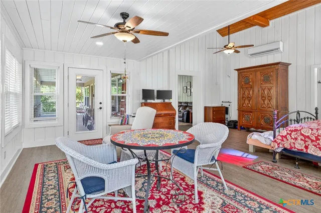 a dining room with furniture a rug and a large window