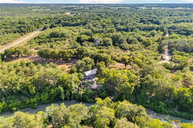 a view of a city with lush green forest