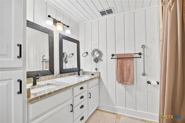 a view of a hallway with wooden floor and closet area