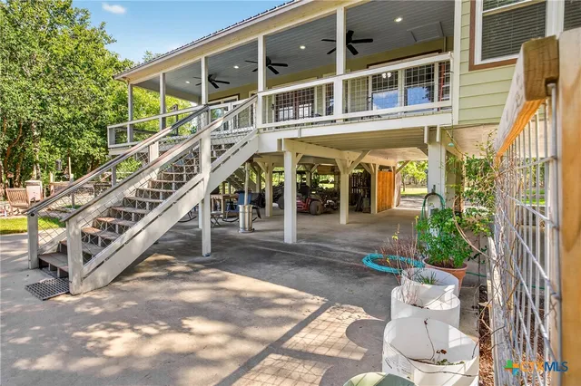a view of a house with a yard deck and a slide