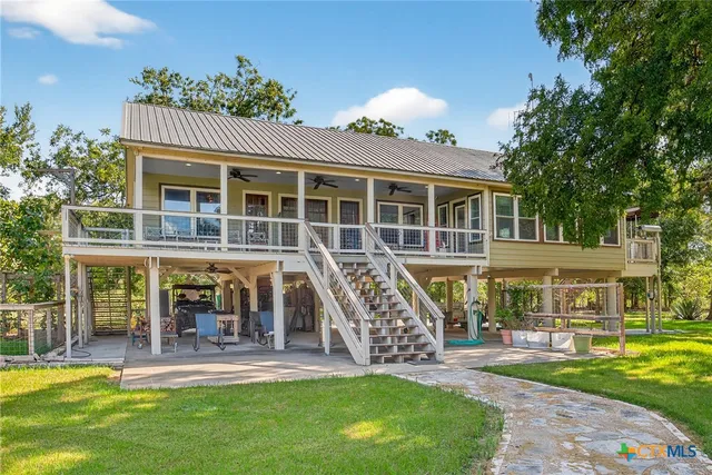 a view of a chair and tables in the balcony