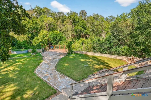 a view of backyard with swimming pool and patio