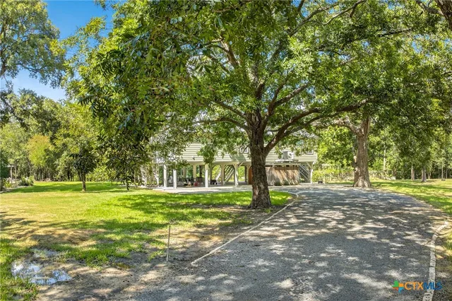 a view of a house with a yard and furniture