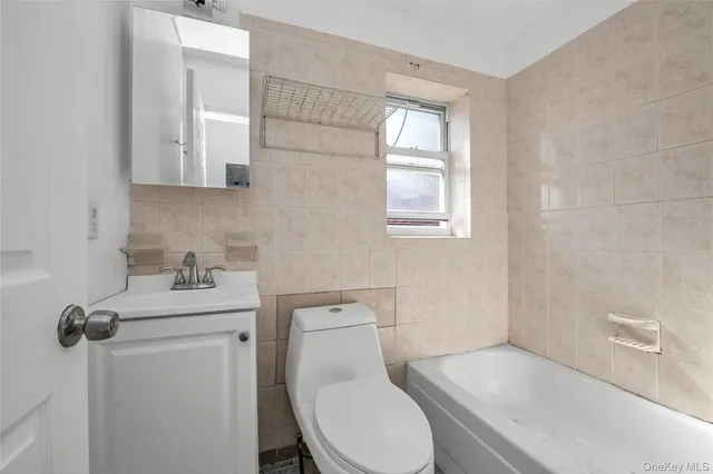 a white toilet sitting next to a bathroom sink