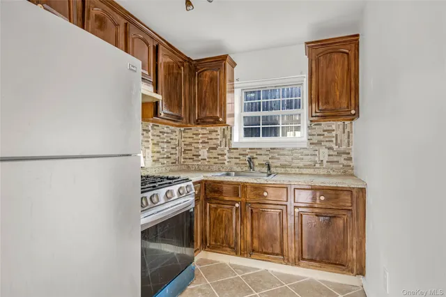 a kitchen with stainless steel appliances granite countertop a sink and a stove