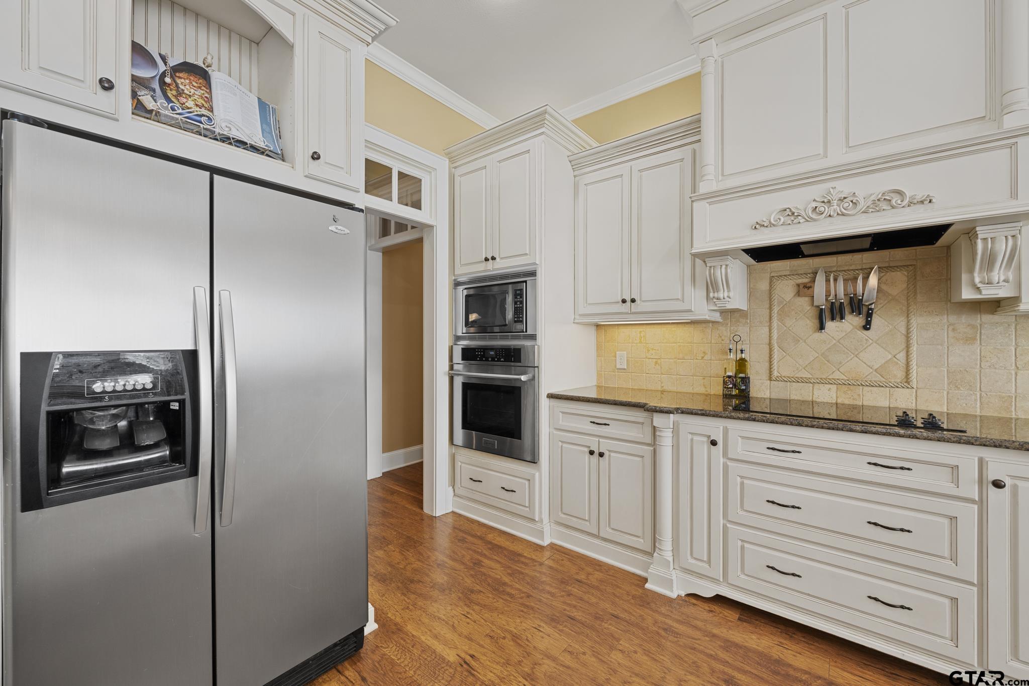 19950 Post Oak Bend Lindale, TX 75771 - Photo 12 of 42 a kitchen with granite countertop white cabinets and stainless steel appliances