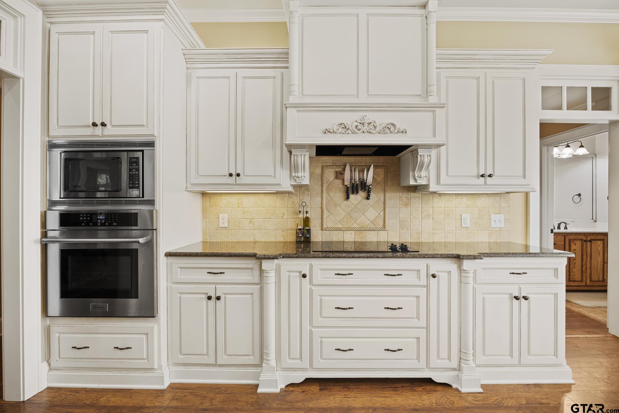 19950 Post Oak Bend Lindale, TX 75771 - Photo 13 of 42 a kitchen with granite countertop white cabinets and stainless steel appliances