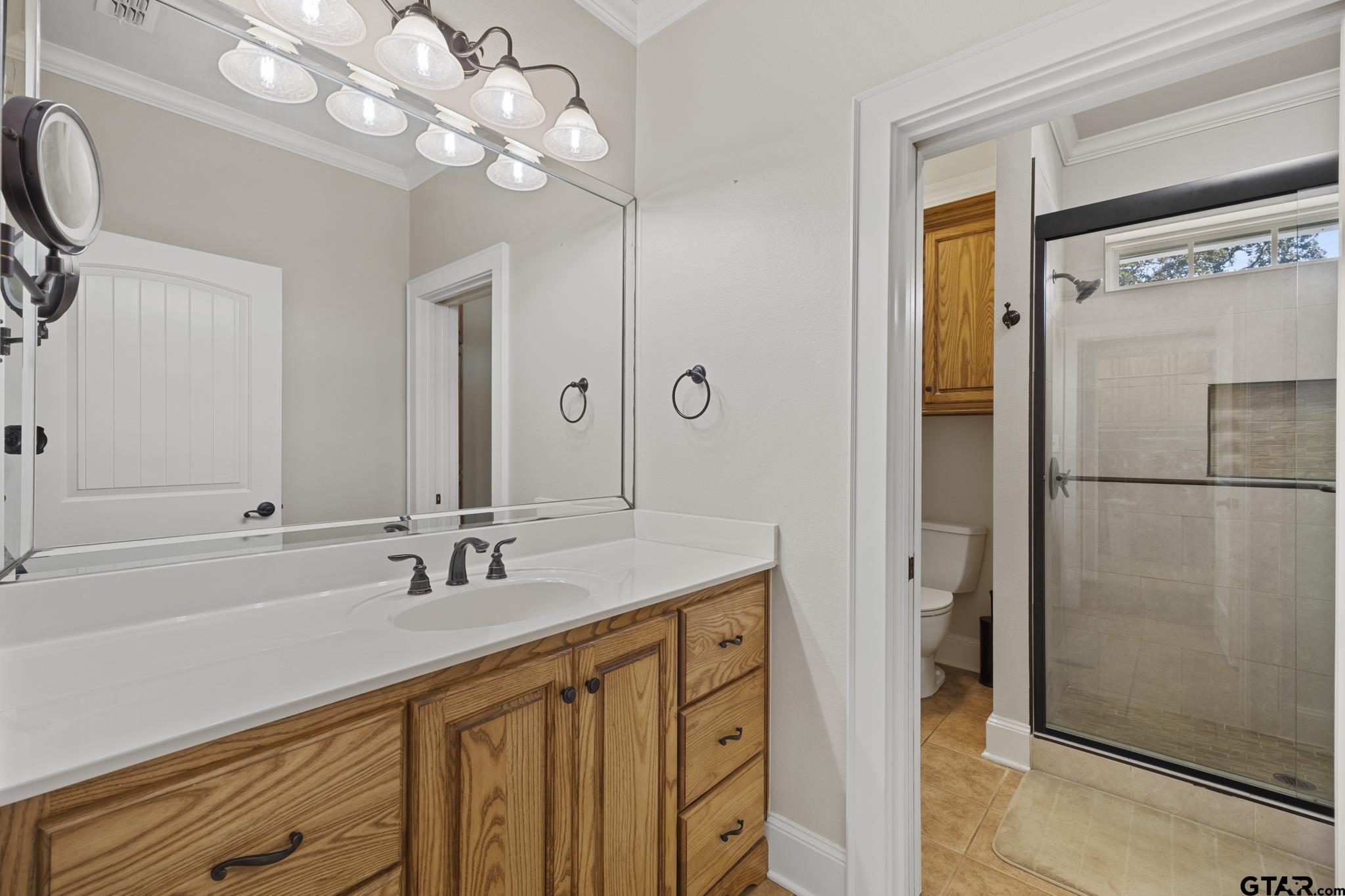 19950 Post Oak Bend Lindale, TX 75771 - Photo 19 of 42 a bathroom with a sink a mirror and a shower