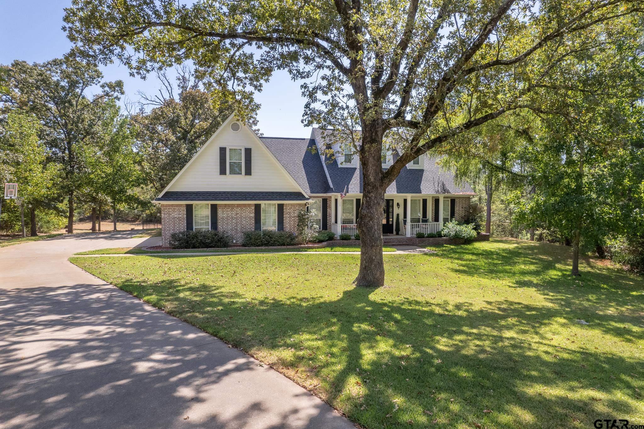 19950 Post Oak Bend Lindale, TX 75771 - Photo 2 of 42 a front view of a house with a yard and large trees