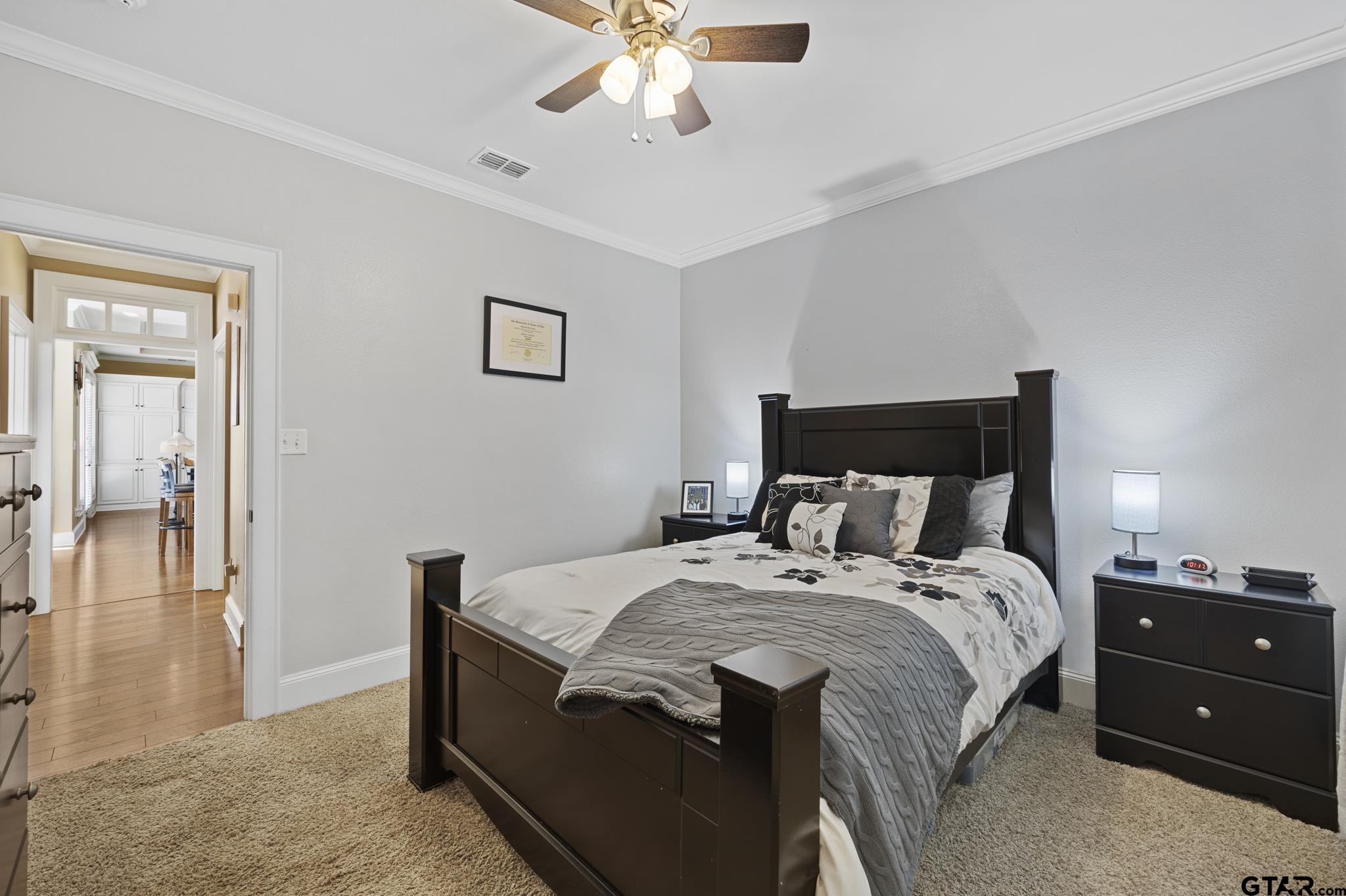 19950 Post Oak Bend Lindale, TX 75771 - Photo 21 of 42 a bedroom with a bed and a chandelier