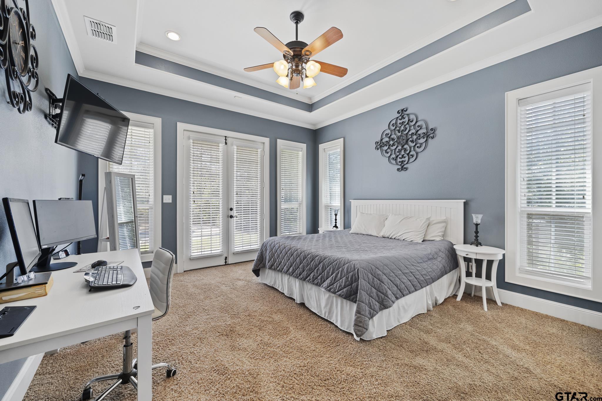 19950 Post Oak Bend Lindale, TX 75771 - Photo 22 of 42 a spacious bedroom with a bed and a chandelier