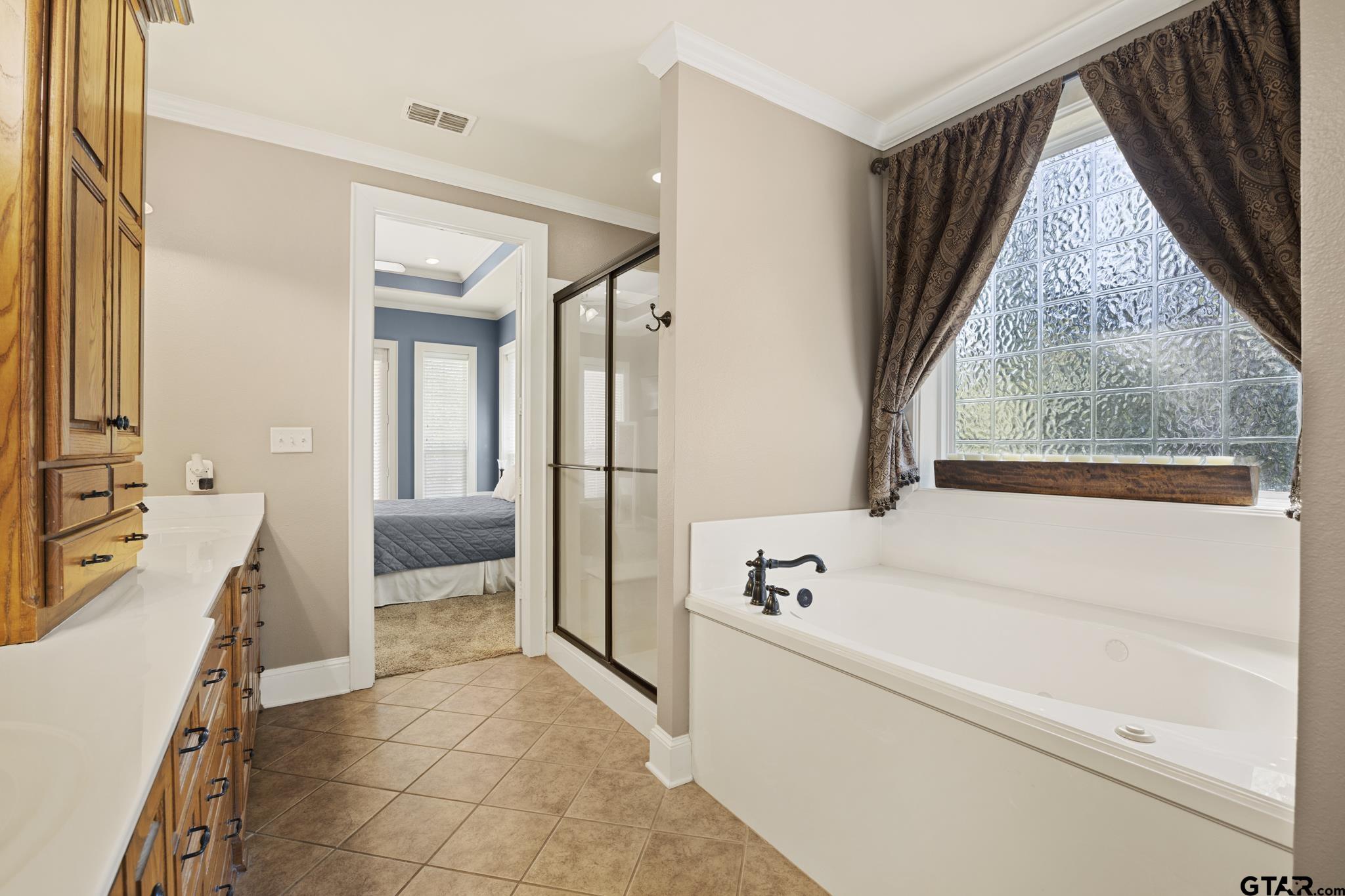 19950 Post Oak Bend Lindale, TX 75771 - Photo 25 of 42 a bathroom with a tub sink and mirror