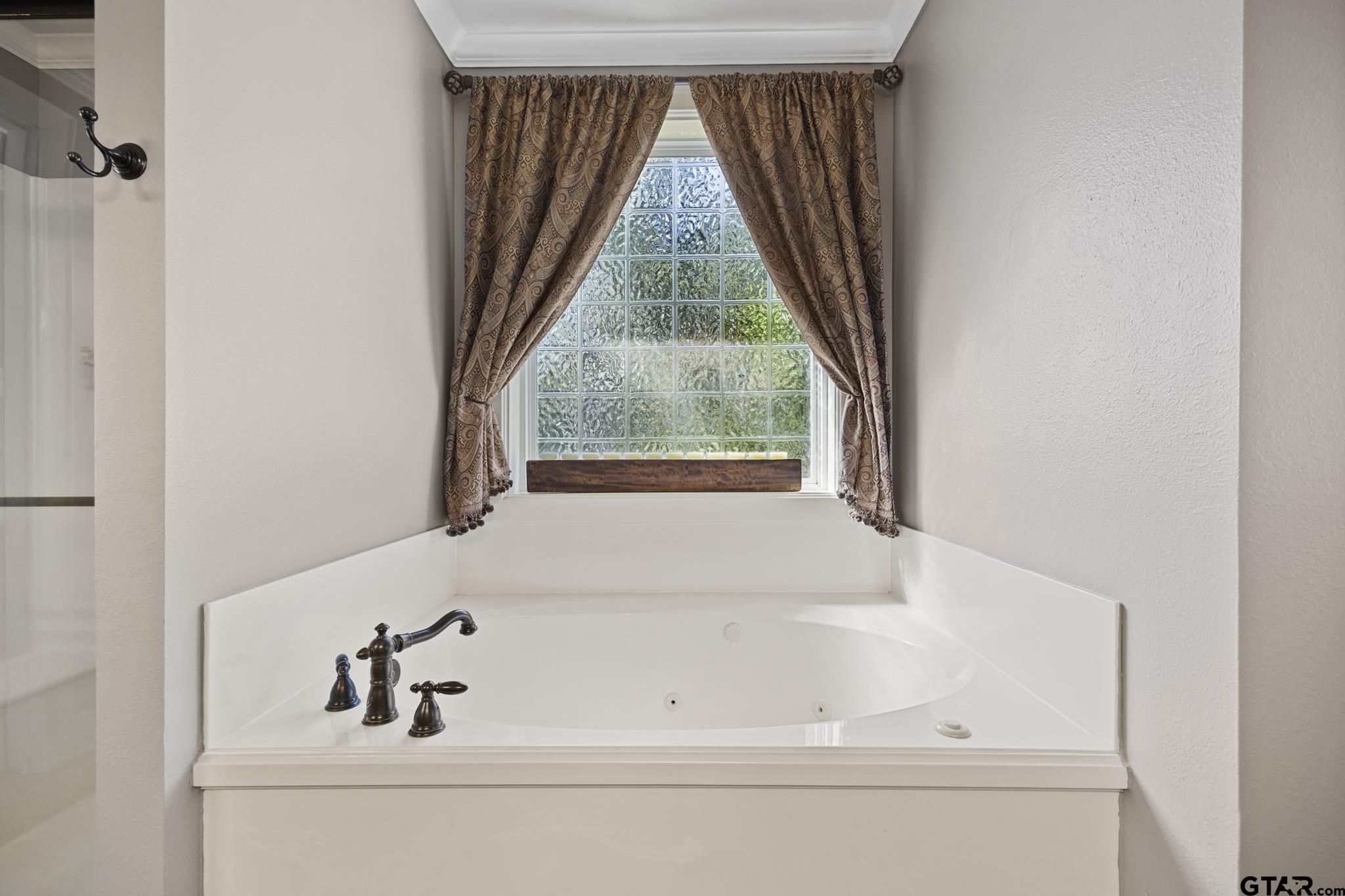 19950 Post Oak Bend Lindale, TX 75771 - Photo 28 of 42 a bathroom with a bathtub and window
