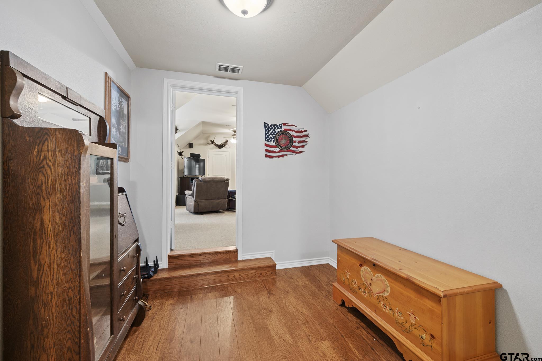 19950 Post Oak Bend Lindale, TX 75771 - Photo 30 of 42 a room with wooden floor and gym equipment