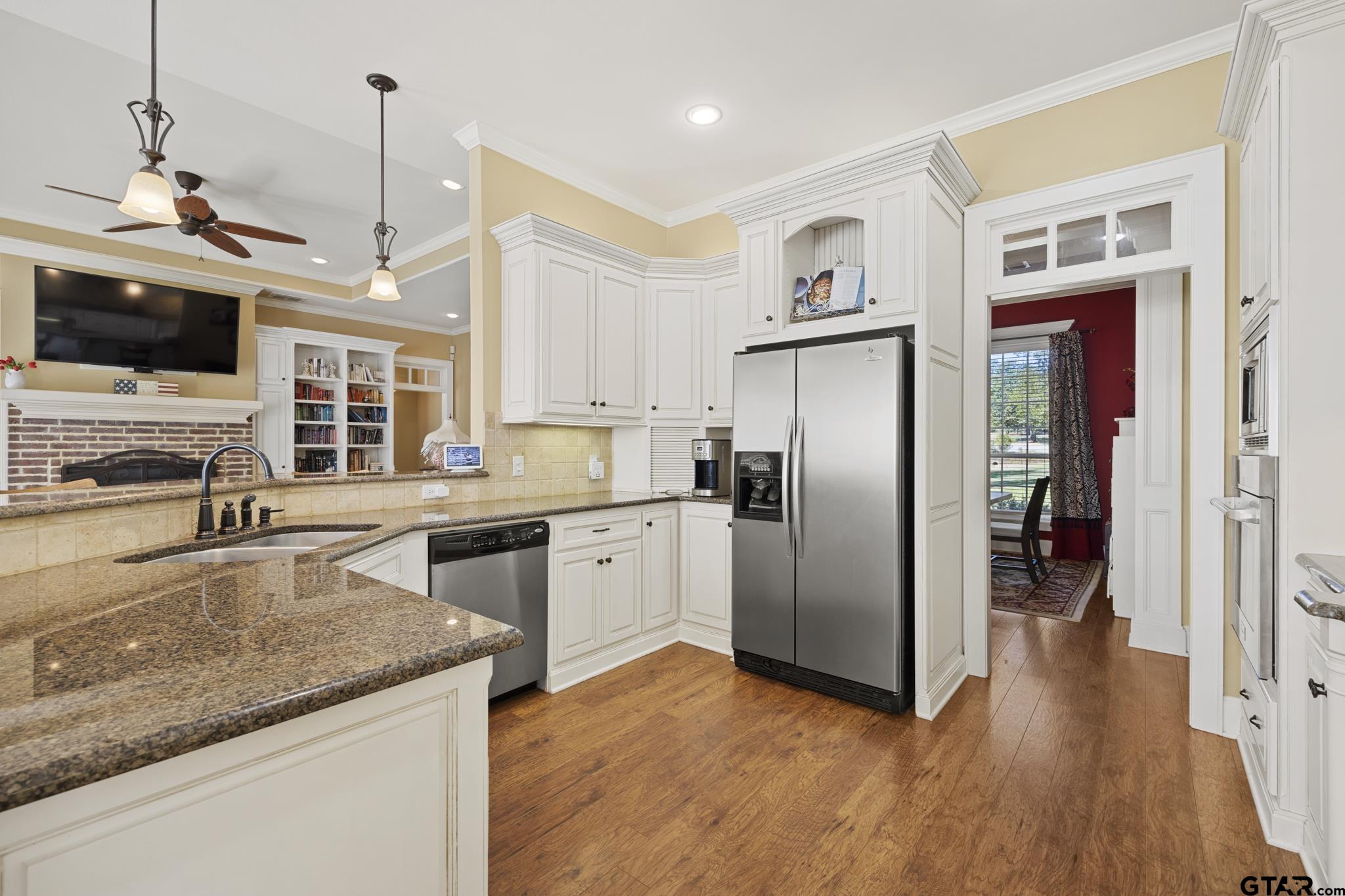 19950 Post Oak Bend Lindale, TX 75771 - Photo 8 of 42 a kitchen with stainless steel appliances granite countertop a refrigerator a oven a sink a dining table and chairs with wooden floor