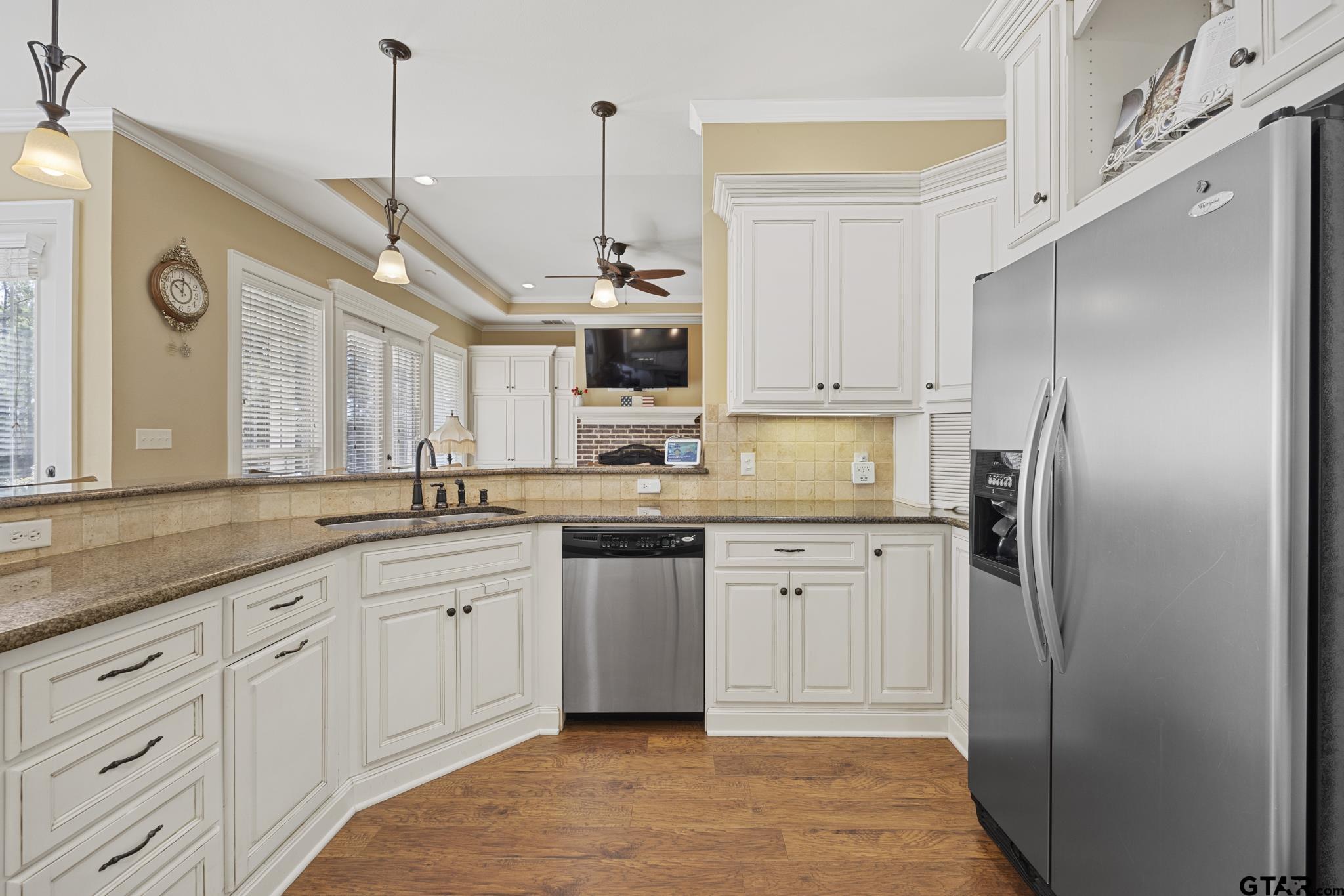19950 Post Oak Bend Lindale, TX 75771 - Photo 10 of 42 a kitchen with stainless steel appliances granite countertop a refrigerator a sink and white cabinets