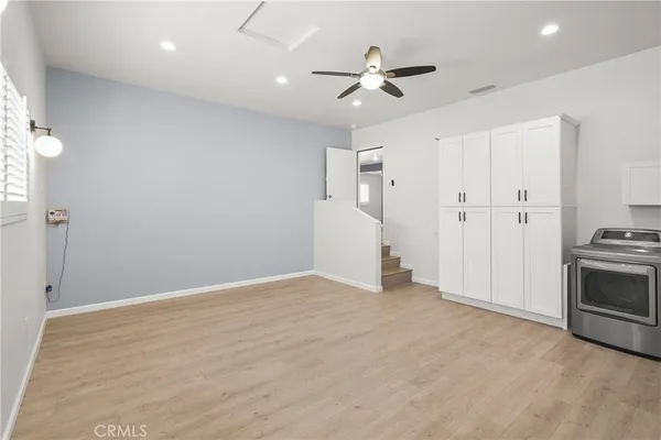 a view of a kitchen with furniture and wooden floor