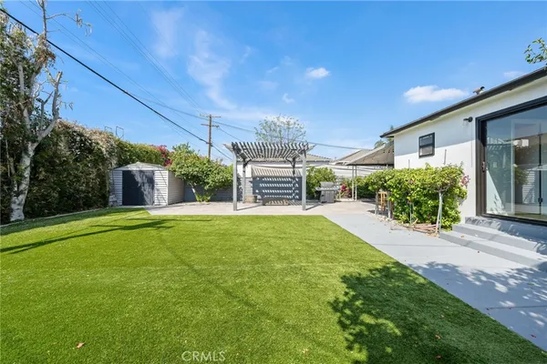 a view of a house with backyard and sitting area