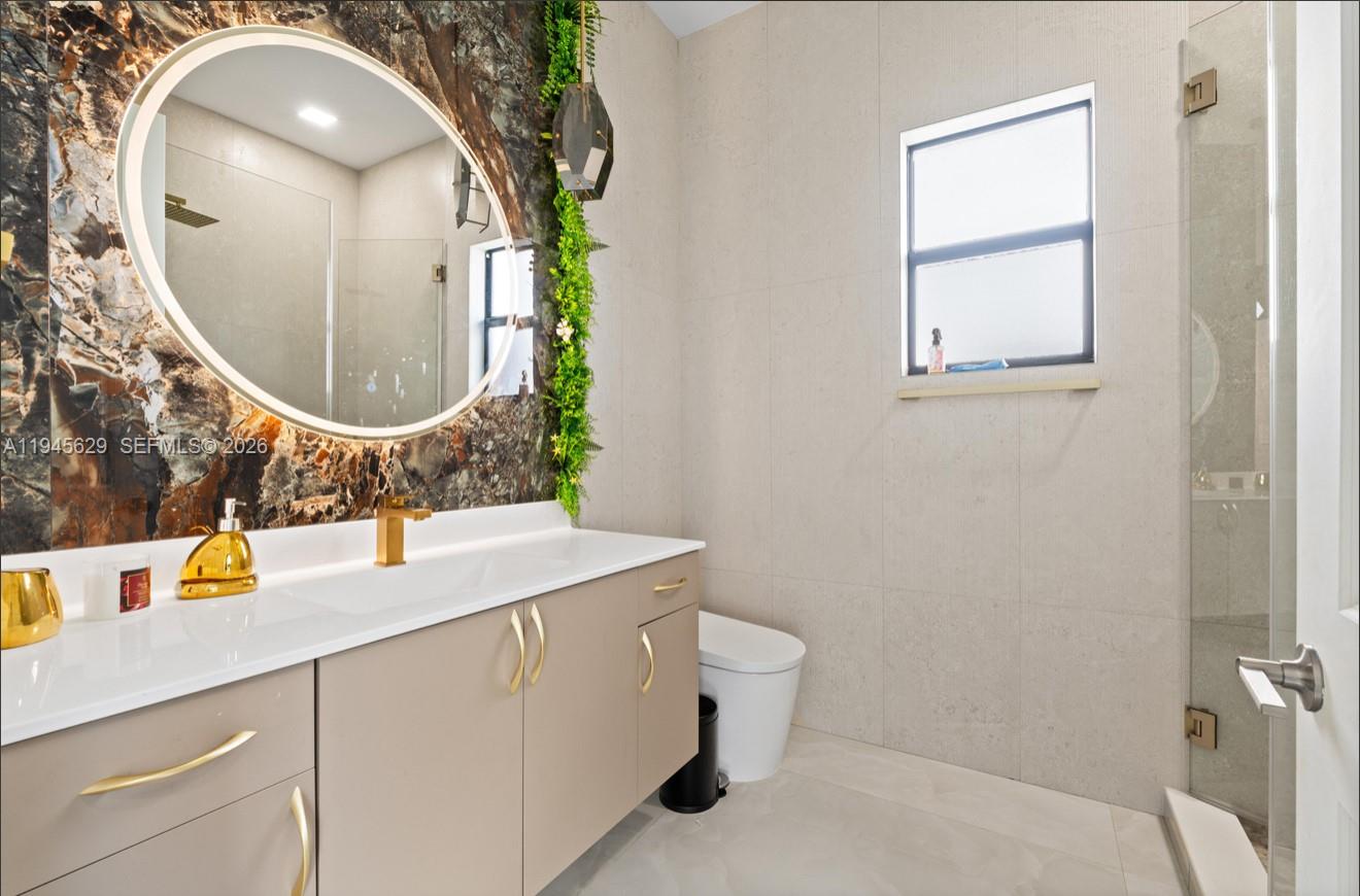 4499 Southwest 173rd Avenue Miramar, FL 33029 - Photo 11 of 11 a bathroom with a sink mirror and vanity