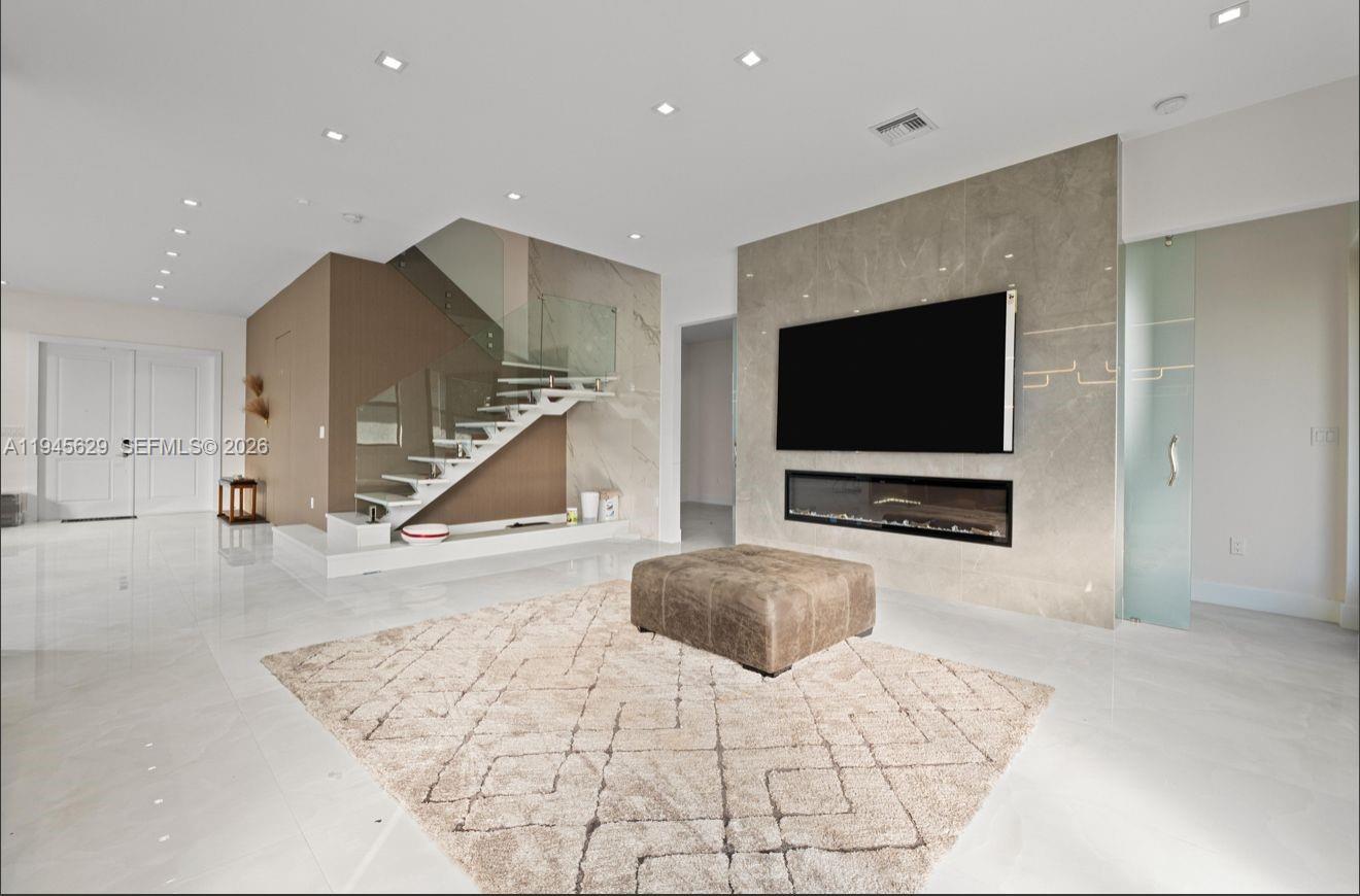 4499 Southwest 173rd Avenue Miramar, FL 33029 - Photo 4 of 11 a living room with furniture and a flat screen tv