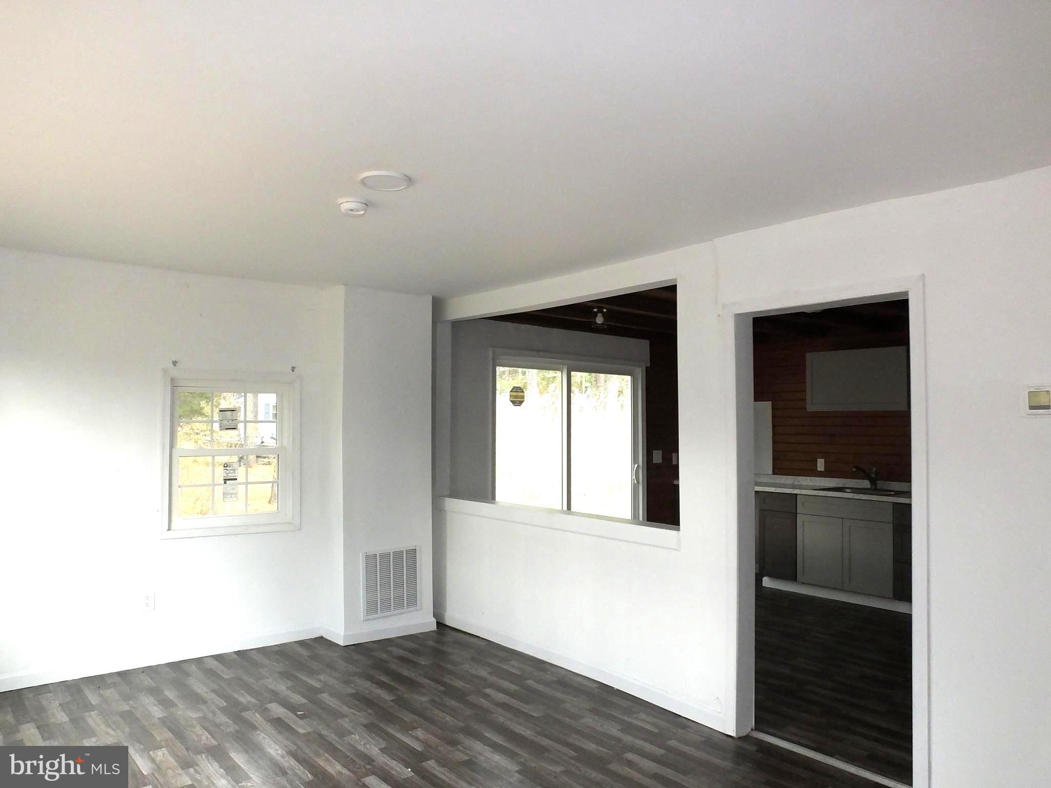 2530 Toddville Road Toddville, MD 21672 - Photo 15 of 24 a view of an empty room with wooden floor and a window