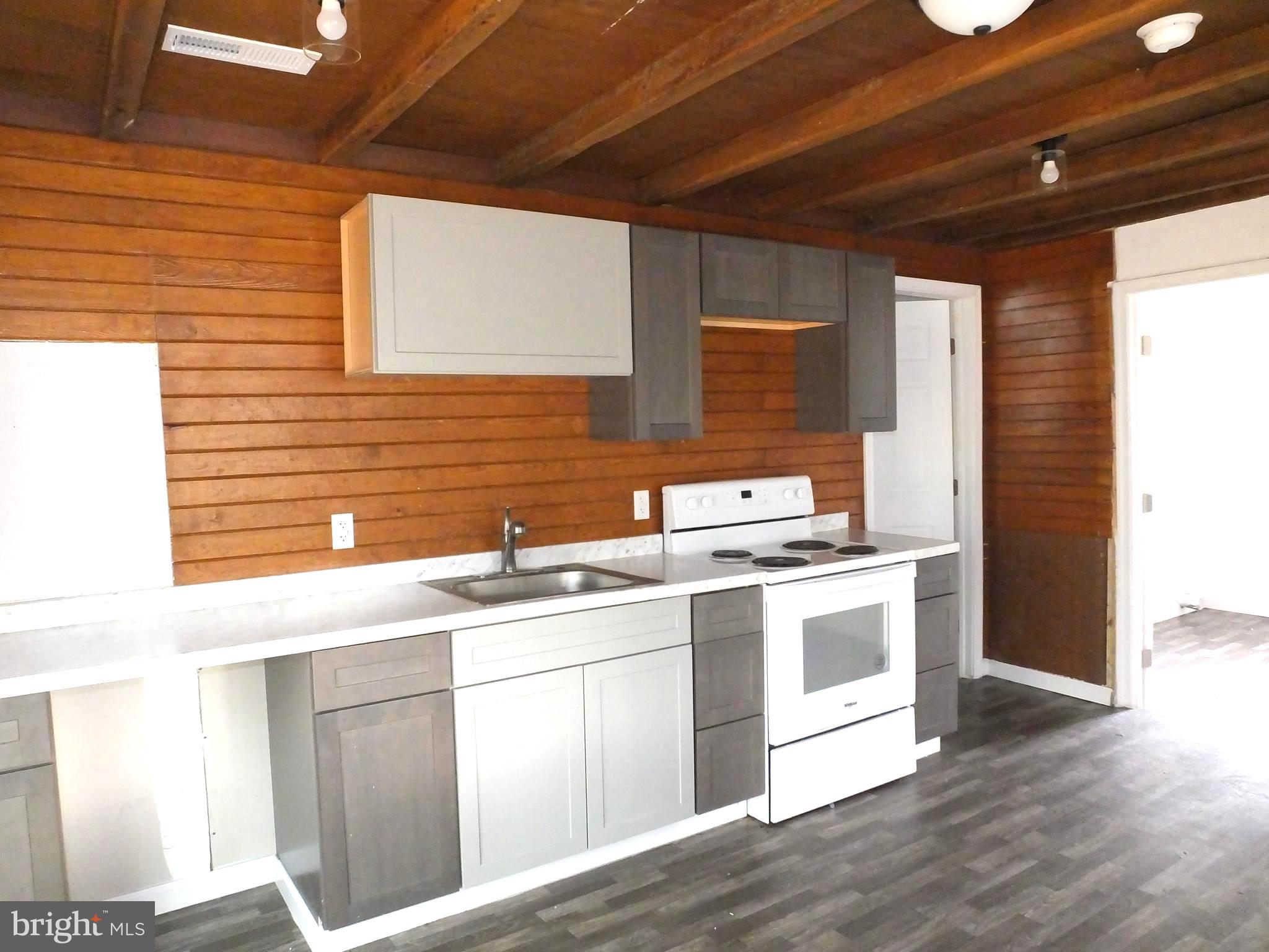 2530 Toddville Road Toddville, MD 21672 - Photo 16 of 24 a kitchen with a sink stove and cabinets