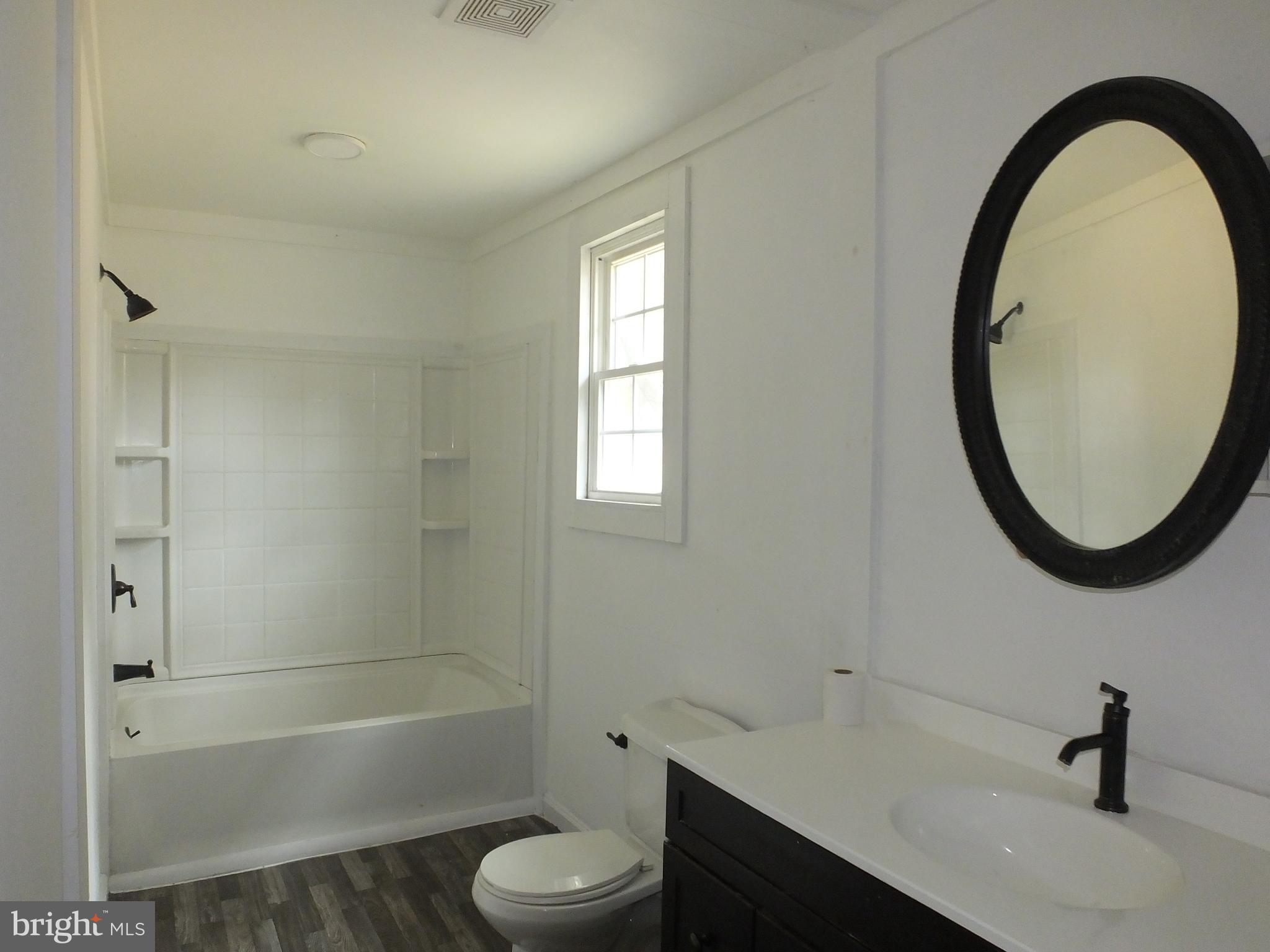2530 Toddville Road Toddville, MD 21672 - Photo 18 of 24 a bathroom with a sink a toilet and a mirror
