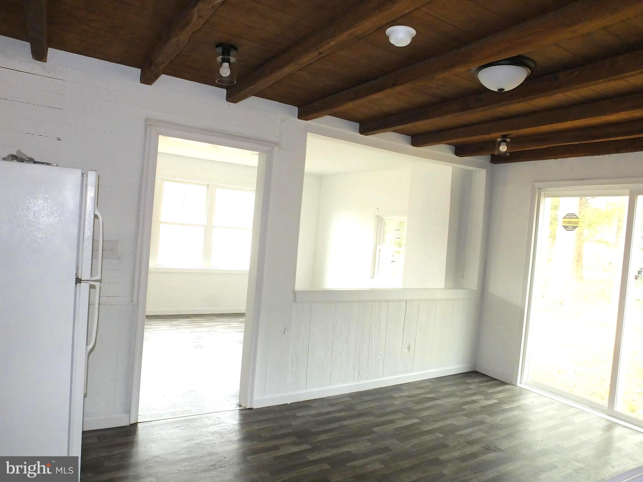 2530 Toddville Road Toddville, MD 21672 - Photo 19 of 24 a view of empty room with wooden floor and fan