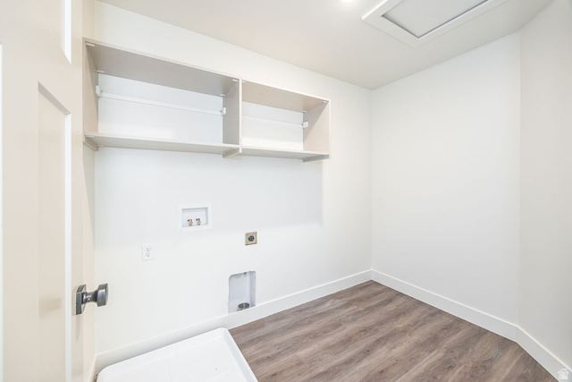 3308 South 1000 West Logan, UT 84321 - Photo 18 of 30 White paneled door with dark hardware, wood-finish flooring, built-in shelving, recessed ceiling light, and access panel