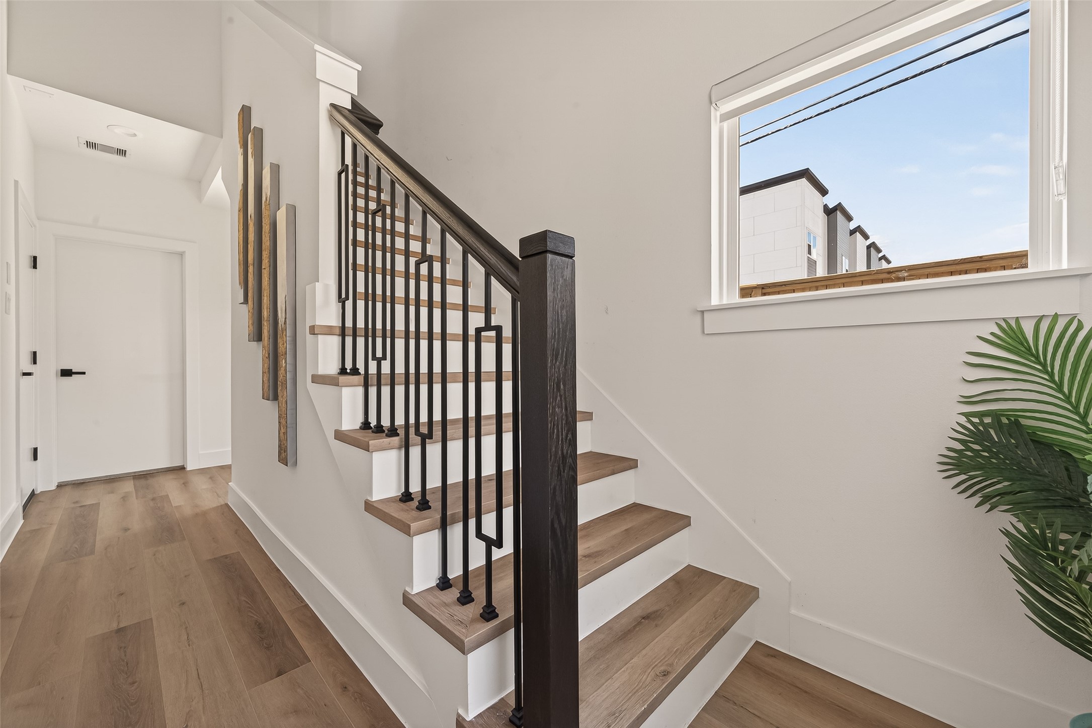 3402 Luca Street Houston, TX 77021 - Photo 3 of 36 a view of a hallway with wooden floor and staircase