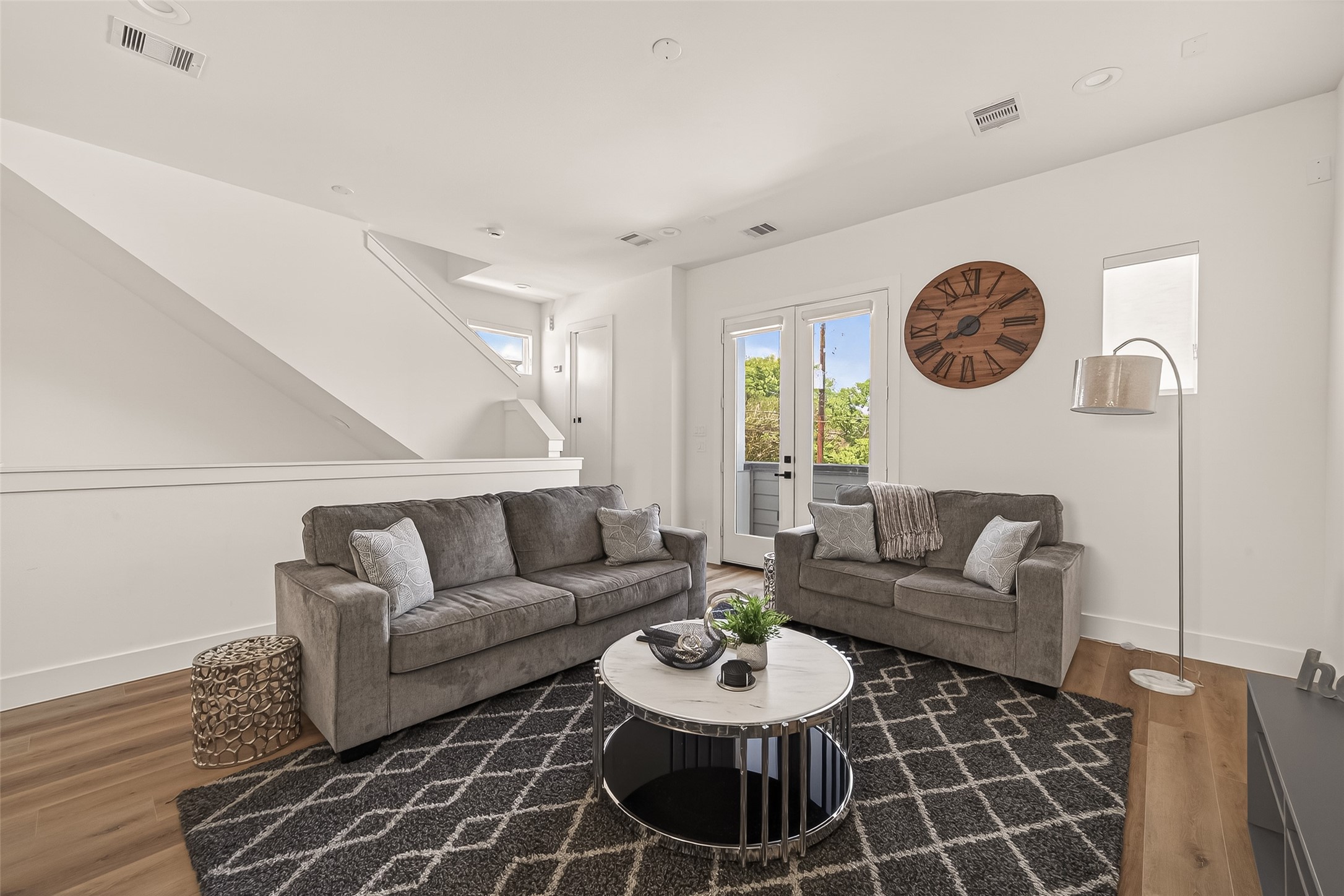 3402 Luca Street Houston, TX 77021 - Photo 5 of 36 a living room with furniture a clock and a rug