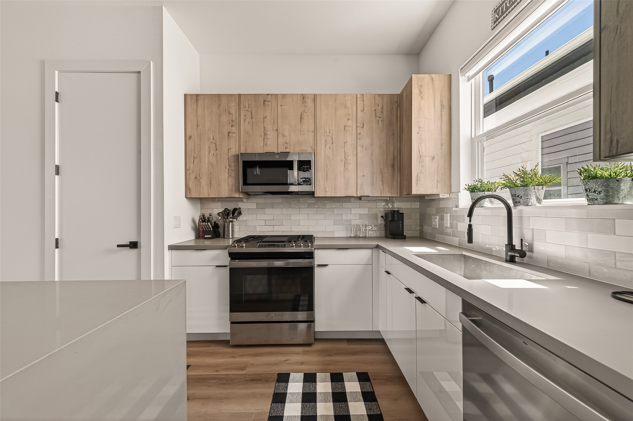 3402 Luca Street Houston, TX 77021 - Photo 9 of 36 a kitchen with kitchen island granite countertop a sink stainless steel appliances and white cabinets