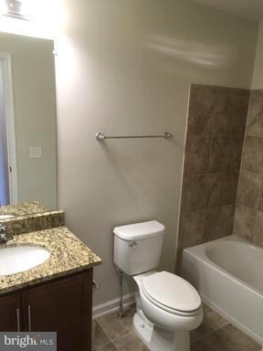 9650 Pullman Place Fairfax, VA 22031 - Photo 12 of 14 a white toilet sitting next to a bath tub and a sink