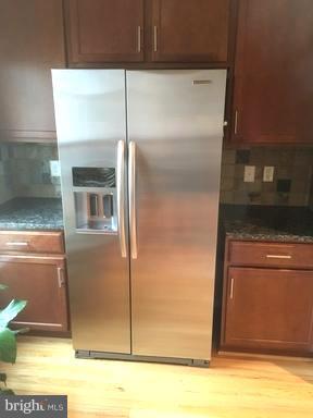 9650 Pullman Place Fairfax, VA 22031 - Photo 4 of 14 a kitchen with metallic refrigerator freezer and a dishwasher