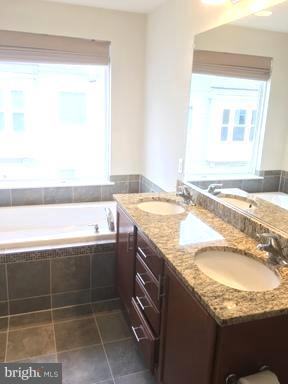9650 Pullman Place Fairfax, VA 22031 - Photo 6 of 14 a bathroom with a granite countertop sink and a mirror