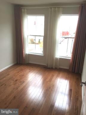 9650 Pullman Place Fairfax, VA 22031 - Photo 7 of 14 an empty room with wooden floor and windows