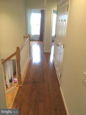 9650 Pullman Place Fairfax, VA 22031 - Photo 9 of 14 a view of a hallway with wooden floor and staircase