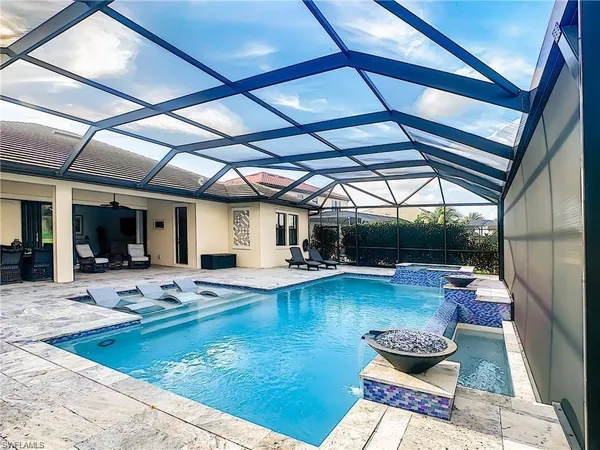 a view of swimming pool with outdoor seating