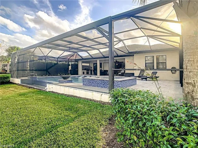 a view of swimming pool with outdoor seating and a pathway