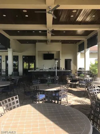 a living room with patio furniture and a fountain