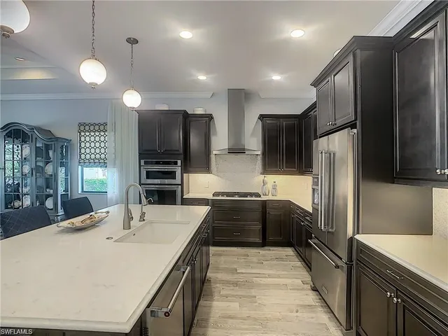 a large kitchen with a large counter top appliances and cabinets