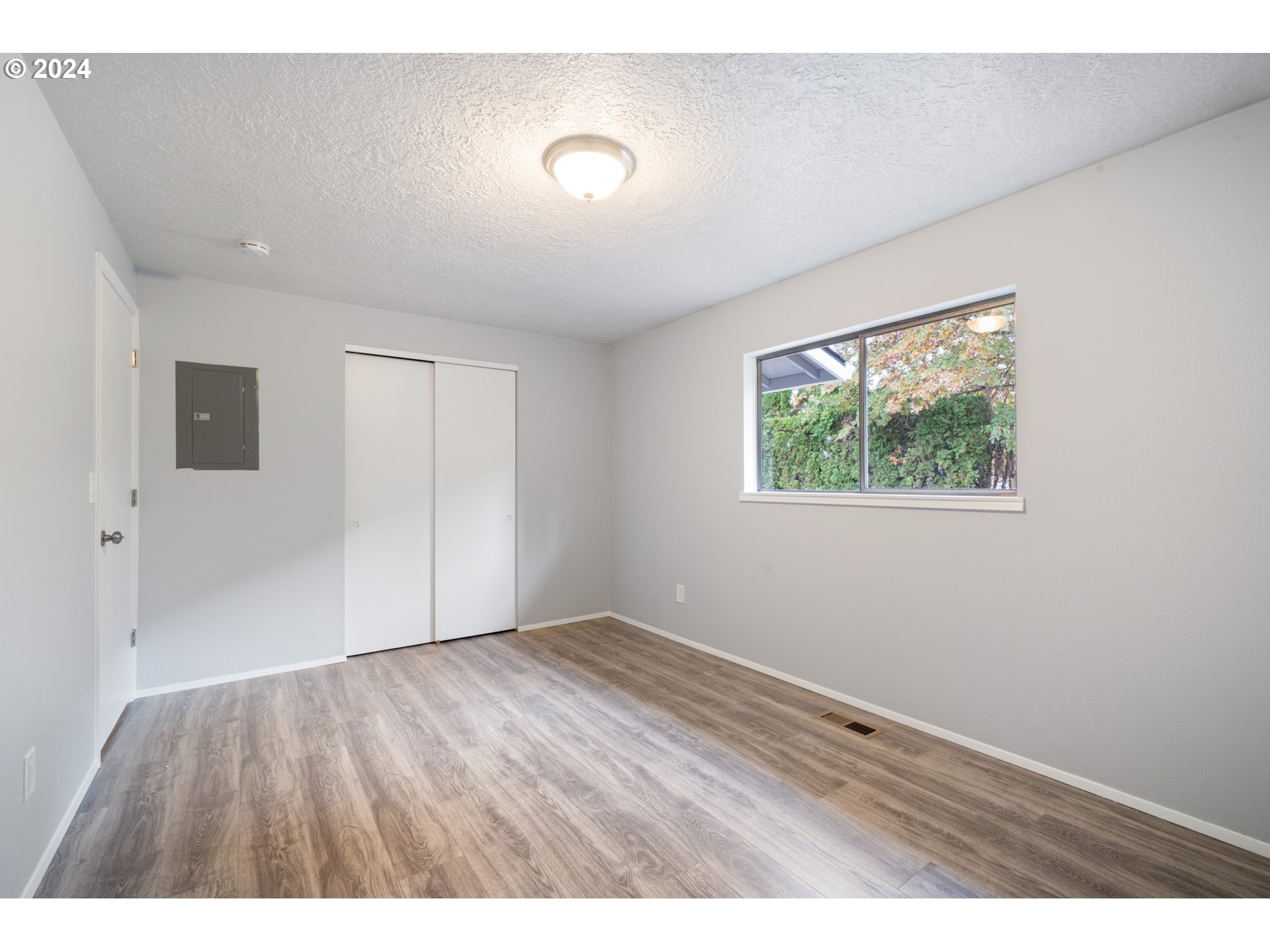 12841 Southeast Foster Road Portland, OR 97236 - Photo 34 of 48 a view of an empty room with wooden floor